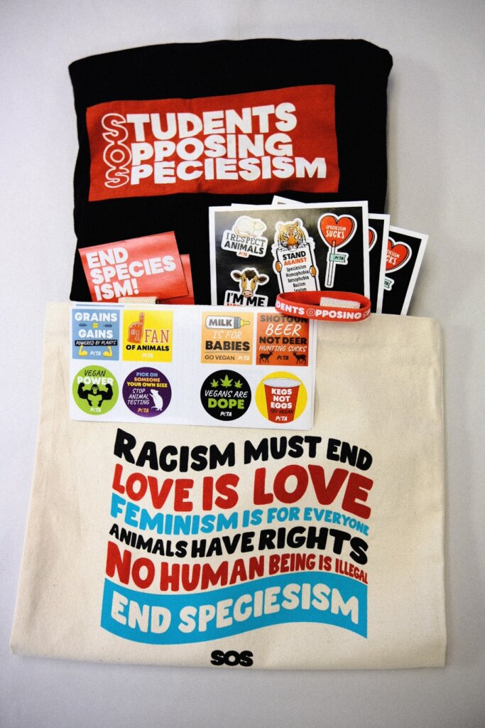 "End Speciesism" tote bag filled with animal rights literature, stickers, and a Students Opposing Speciesism t-shirt
